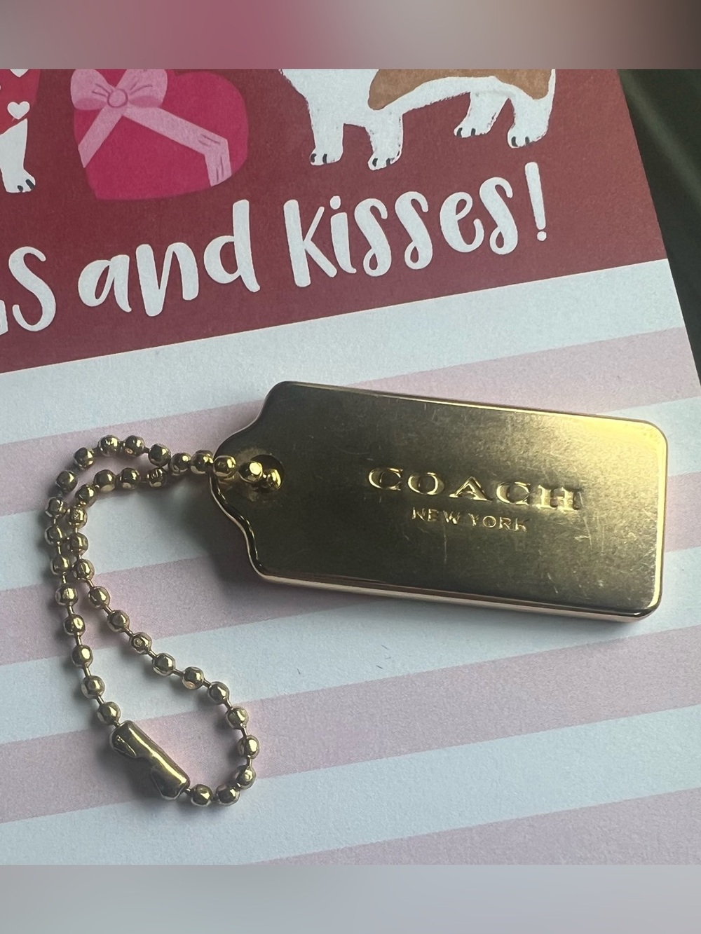 Coach gold tone metal hang tag